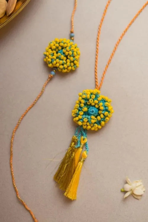 Samoolam Yellow Coral Crochet Rakhi & Lumba Set (Set Of 2)