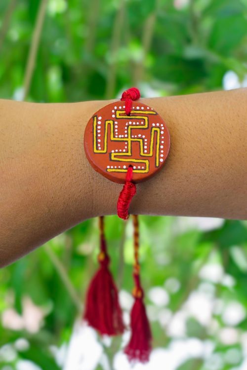 Antarang  (Set Of 2) Terracotta. Swastik- Handpainted Terracotta Rakhi.  Made By Divyang Rural Women