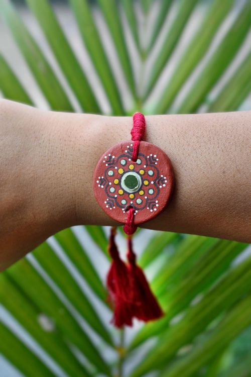 Antarang  (Set Of 2) Terracotta. Antarang-Terracotta. Dharti- Handpainted Terracotta Rakhi Made By Divyang Rural Women