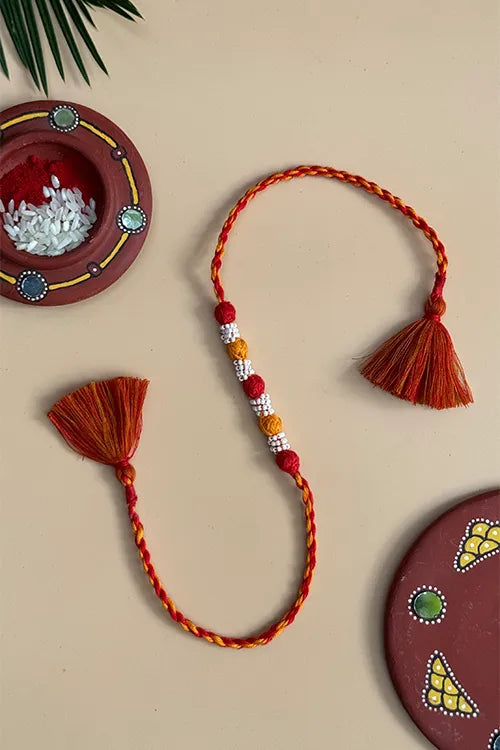Antarang- Navrang Bead Rakhi- Set Of 2- Orange, Blue Rakhi + Red, Yellow Rakhi