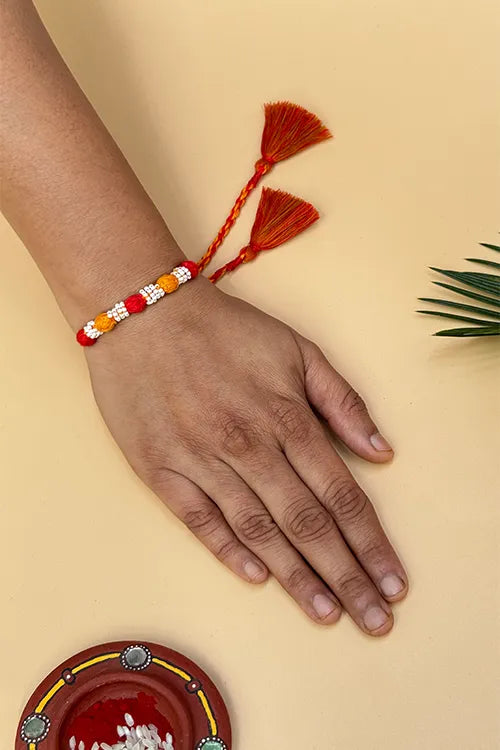 Antarang- Navrang Bead Rakhi- Set Of 2- Orange, Blue Rakhi + Red, Yellow Rakhi