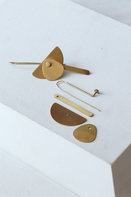 Lukka Chuppi Eterna balanced earrings with brass off cut sheet.