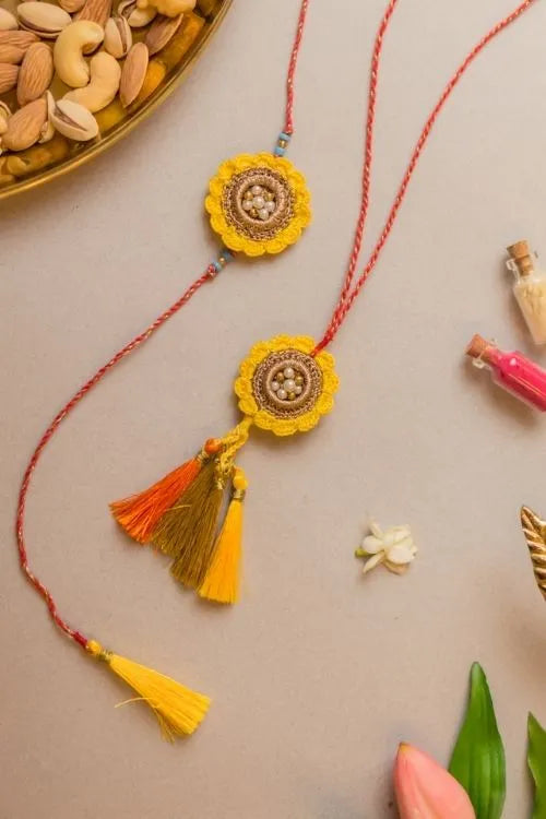 Samoolam Marigold Crochet Rakhi & Lumba Set (Set Of 2)